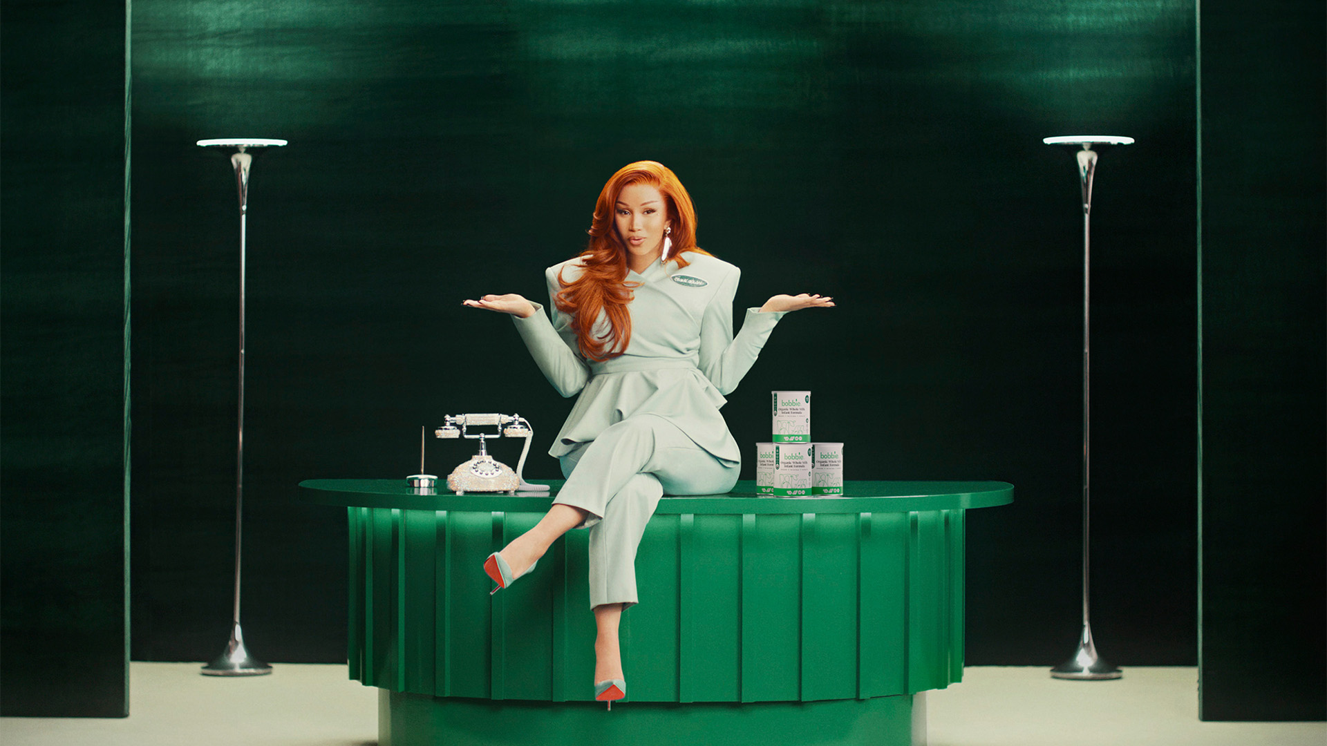 Cardi B sitting on a desk