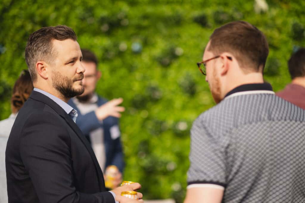 Two people talking at the Babel PR UpOntheRoof Party 2023