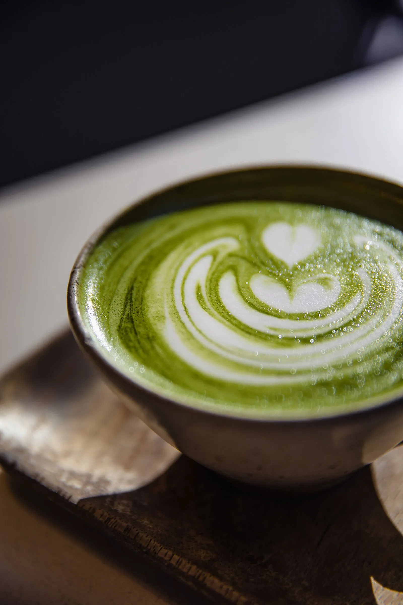 Close-up of matcha latte with heart latte art