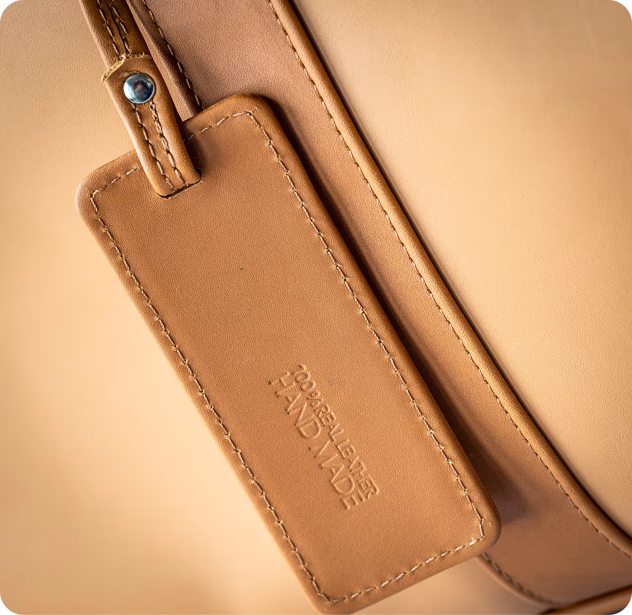 A tan bag with a tag attached to it.