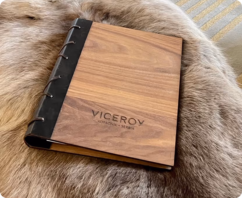 A wooden notebook sitting on top of a fur covered chair.