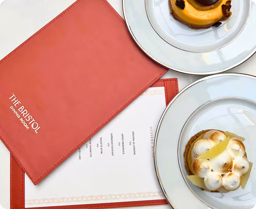 Two plates of food on a table with a red napkin.