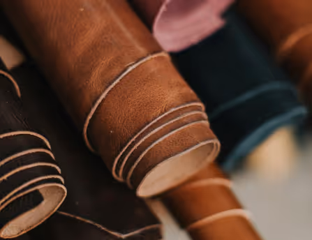 A close up of a bunch of different colored leathers.