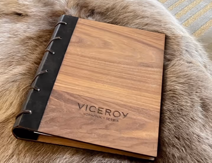 A wooden notebook sitting on top of a fur covered chair.