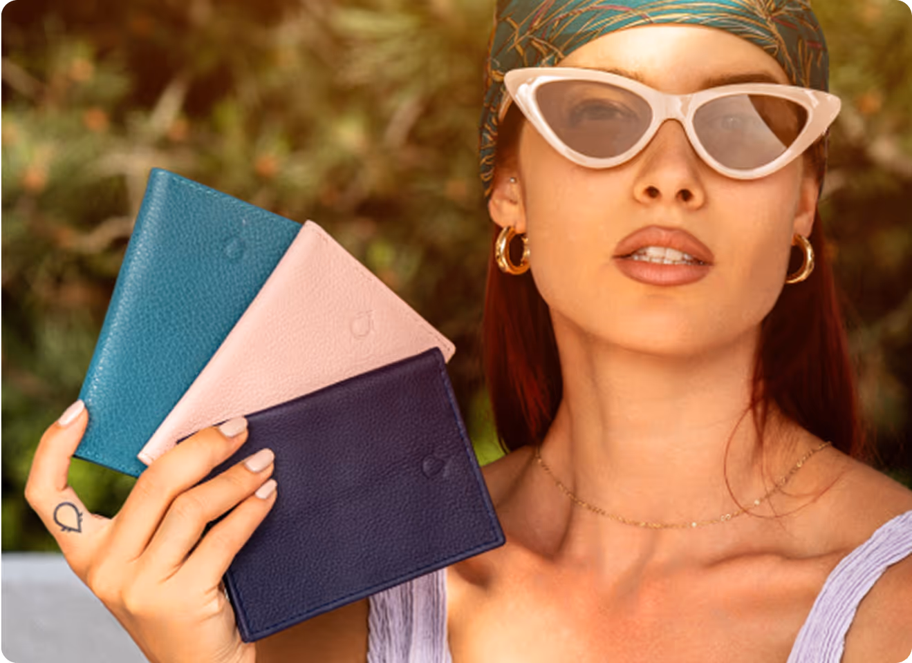 A woman wearing sunglasses and holding a wallet.