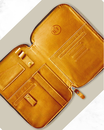 A brown leather case with a zipper on the inside of it.