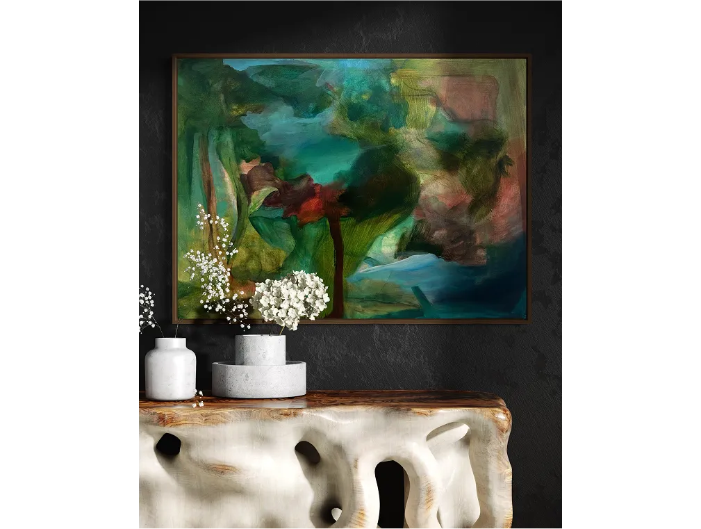 "Blood Pact" in a dark wood frame above a sculptural console, with bold green and red tones, accented by white floral vases.