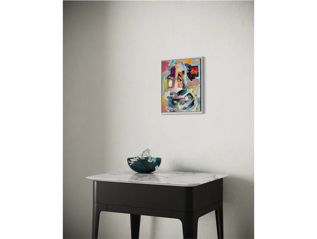 Art titled "You'll Never Change" hangs above a black table with marble top and a decorative glass bowl.