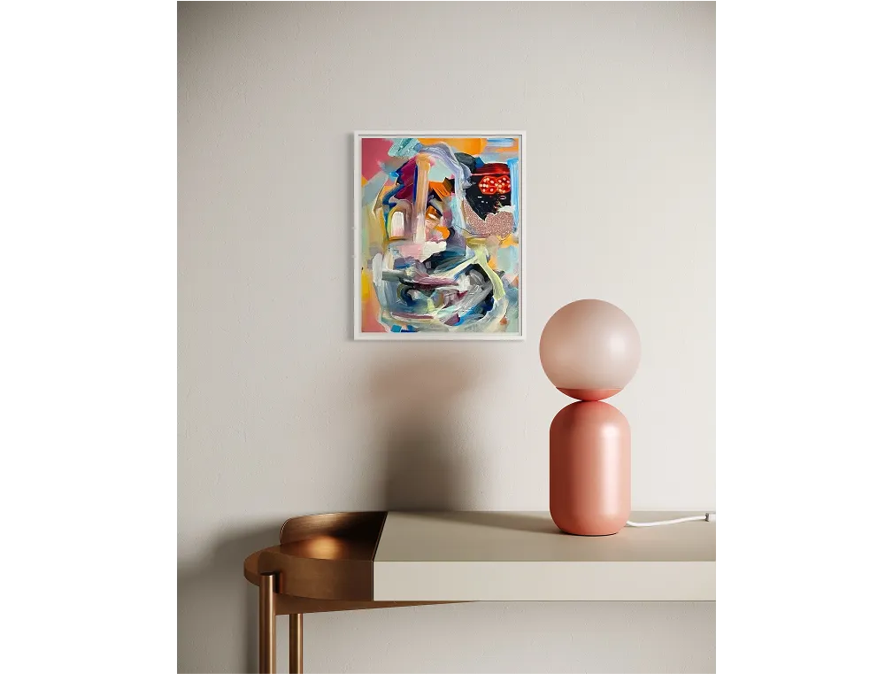 Minimalist interior with soft lighting; artwork titled "You'll Never Change" hangs on a neutral-toned wall.