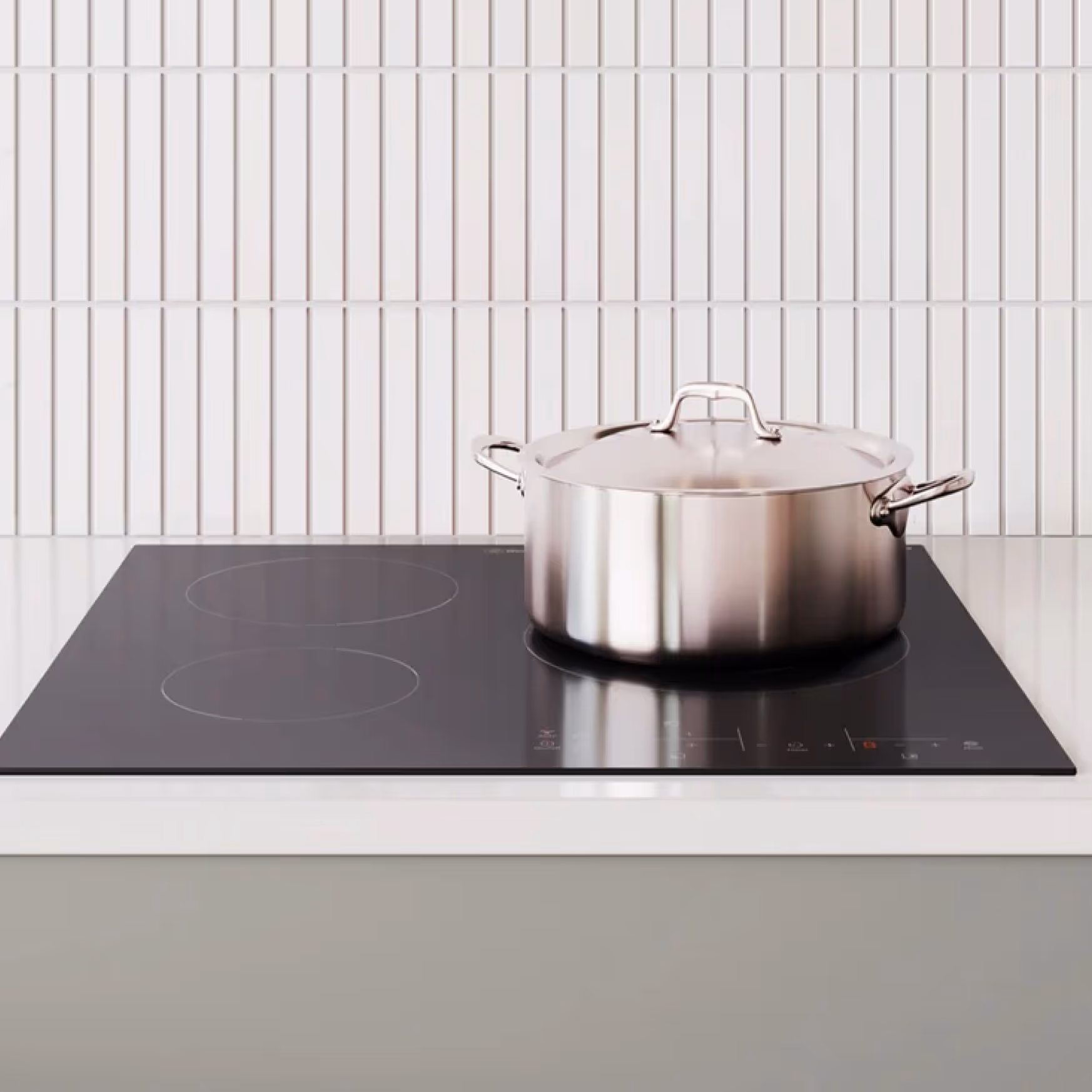 Height-adjustable electric stovetop bench with built-in cooktop, designed to lower or raise for safe and accessible cooking in Specialist Disability Accommodation kitchens.