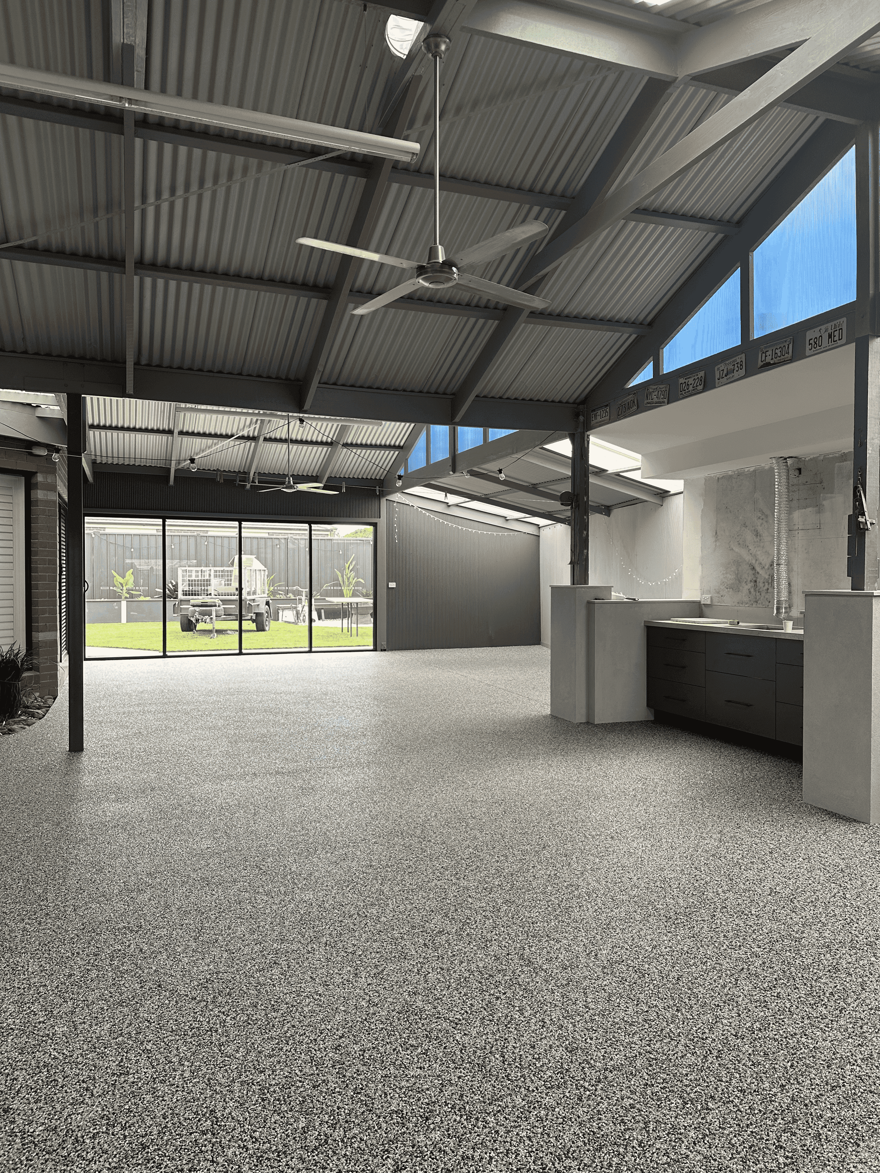 Indoor garage or alfresco area resurfaced with RC-104 Smoke Grey seamless natural stone flooring
