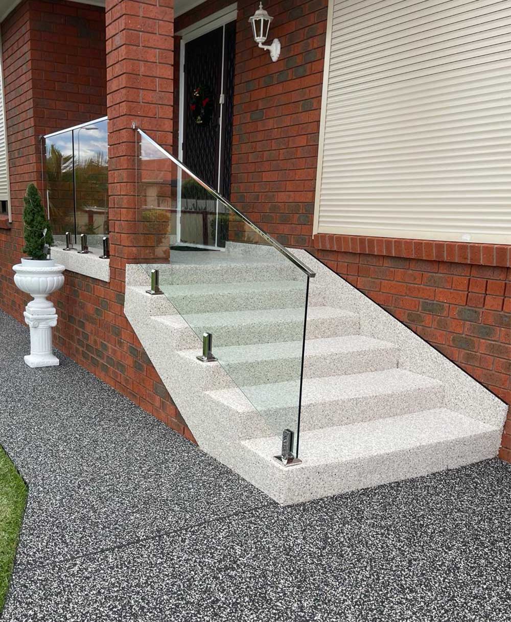 Front porch stairs and landing finished with RC-04 Ivory White and RC-103 Midnight natural stone coating combination