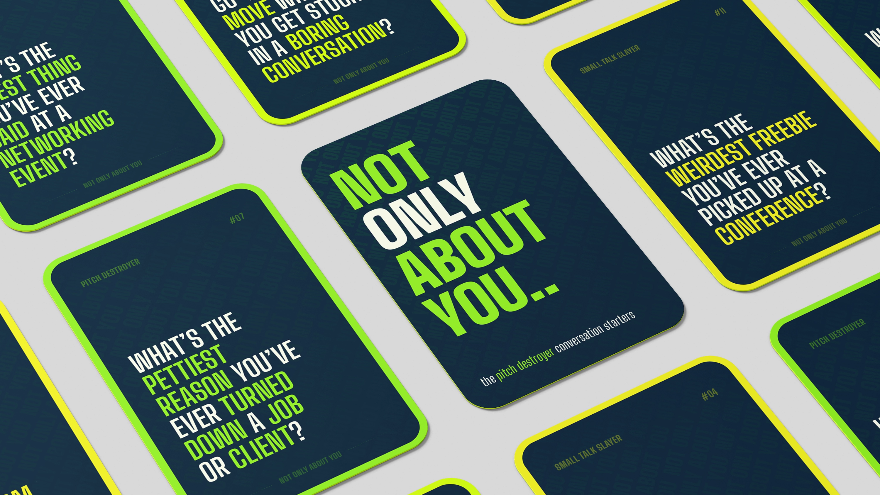 Image showcasing a scene from a video shoot through the lens of a camera. Two women and one man are looking at a magazine on the table, while the rest of the image is blurred