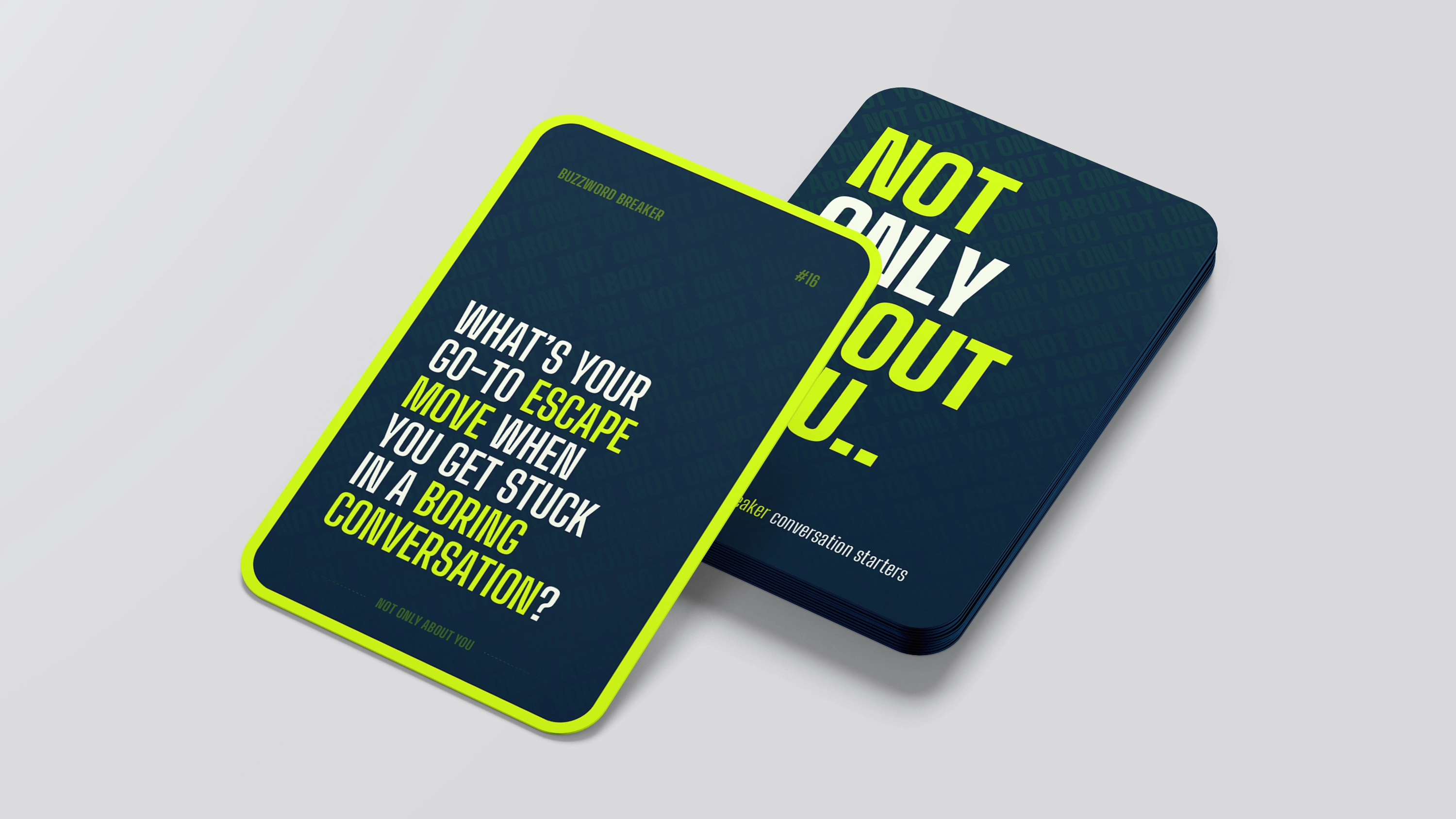 Image showcasing a scene from a video shoot through the lens of a camera. Two women and one man are looking at a magazine on the table, while the rest of the image is blurred