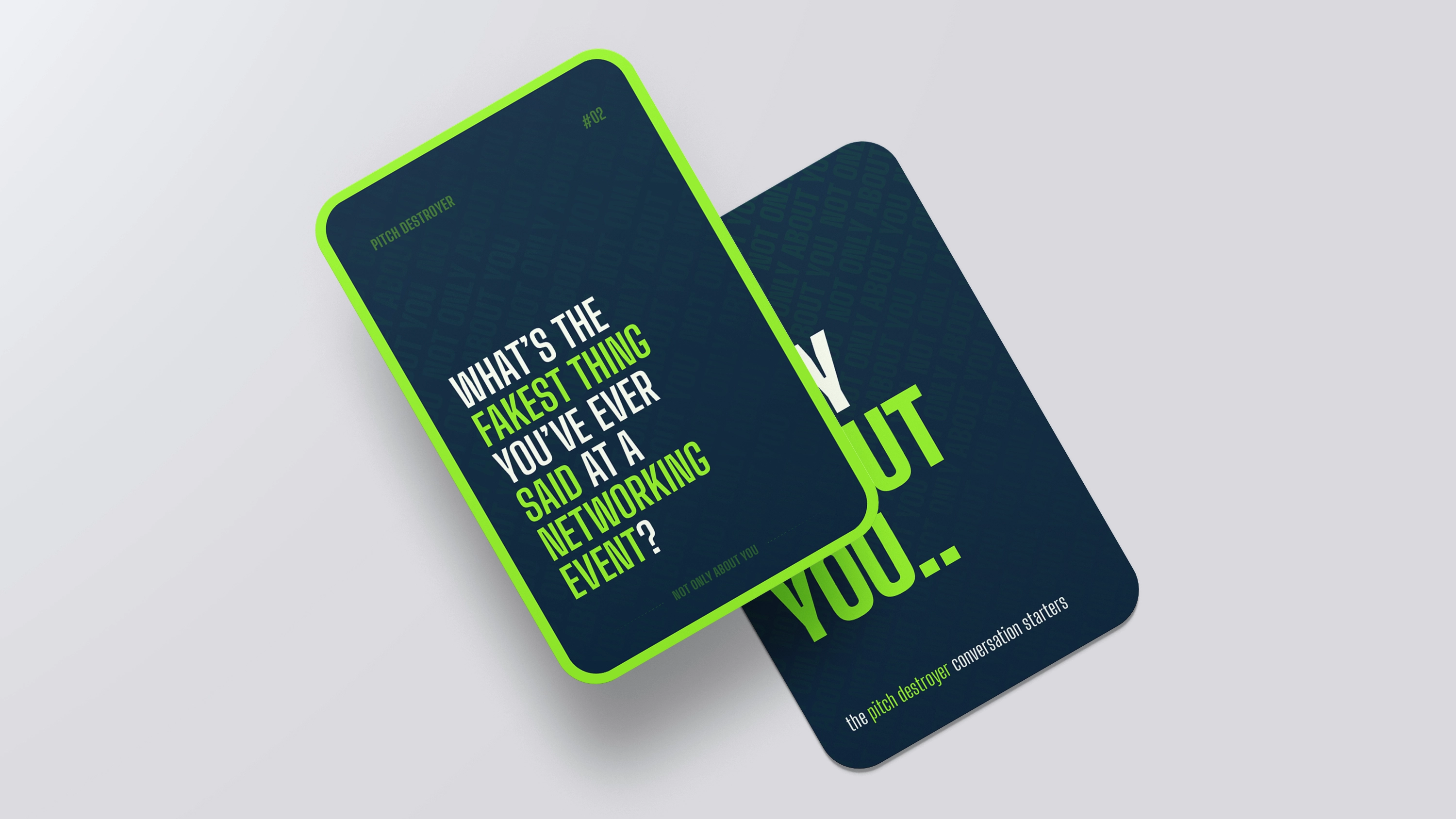 Image showcasing a scene from a video shoot through the lens of a camera. Two women and one man are looking at a magazine on the table, while the rest of the image is blurred