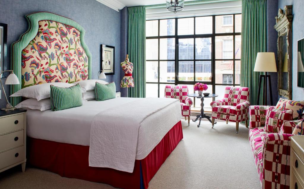 a bedroom with a large bed and a table and chairs at The Whitby Hotel in New York