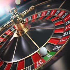 Close up of a red, black and green coloured roulette wheel 