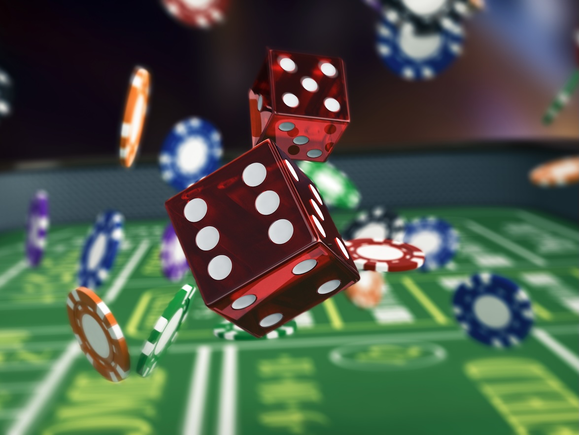 A craps table with dice being thrown across the middle and poker chips flying around the dice
