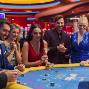 A groupf of friends playing baccarat together in the casino