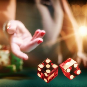 Close up of craps dice being thrown by a female