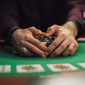 A man holding onto his chips on a live dealer table