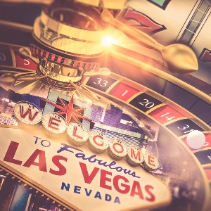 A roulette wheel with a slot machine in the background and WELCOME TO FABULOUS LAS VEGAS NEVADA at the bottom