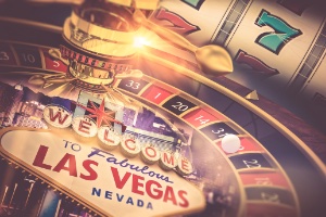 The background is a slot machine, roulete wheel with WELCOME TO FABULOUS LAS VEGAS NEVADA at the bottom in a sign 