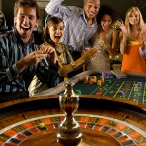 A group of man and female friends excitedly playing roulette together