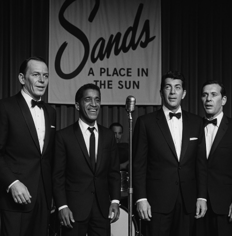 a black and white image of a sinatra lookalike and the rat pack at the sands hotel in vegas