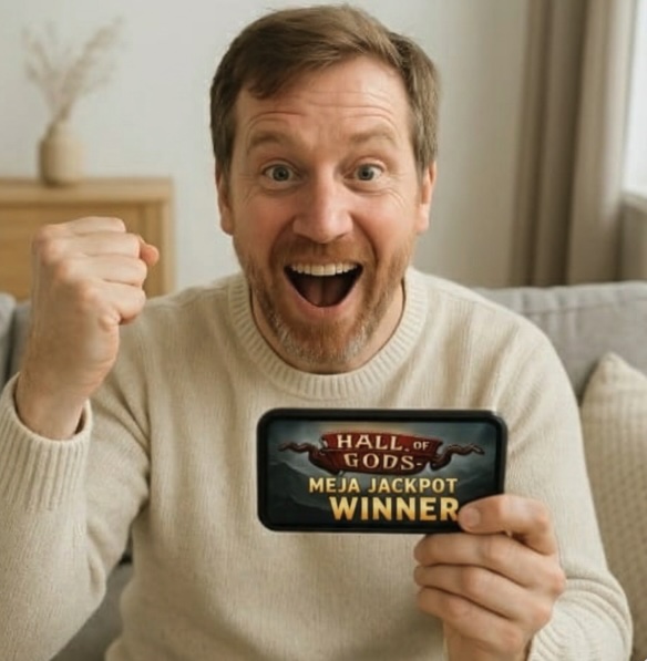 A scandinavian man sitting in his lounge room on the sofa having just won a major prize on a slot game online