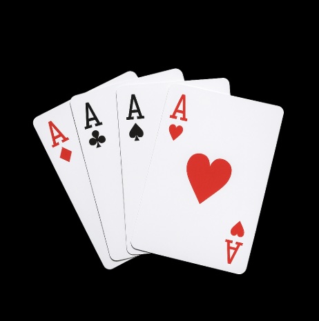 A black background with 4 aces across the 4 different suits