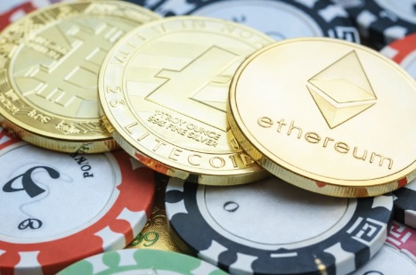 A close up image of crypto currency mixed with poker chips