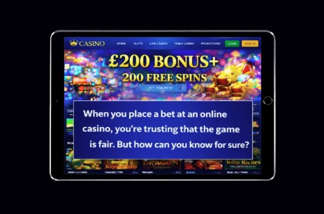 An image of a silver ipad on a black background, on the screen is an online casino background with white text saying WHEN YOU PLACE A BET AT AN ONLINE CASINO, YOU'RE TRUSTING THAT THE GAME IS FAIR. BUT HOW CAN YOU KNOW FOR SURE?