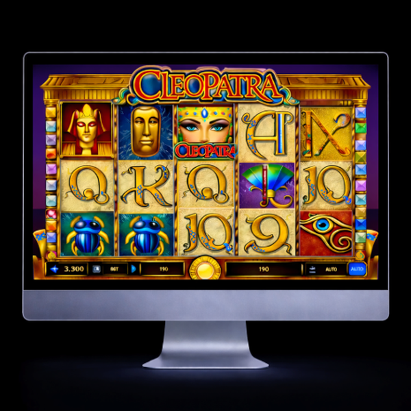 An image of a silver mac monitor with an onscreen image similar to the Cleopatra online slot game