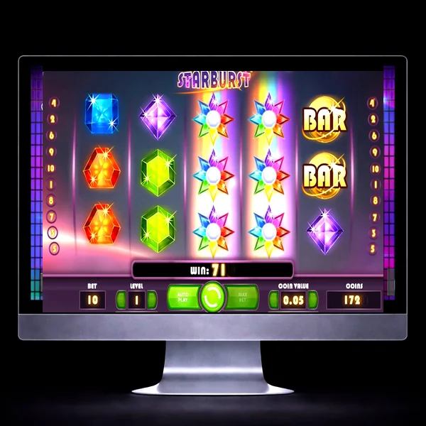 An image of a silver mac on a black background, on the screen is an image similar to the STARBURST online slot game