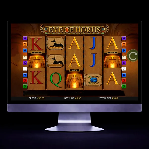 An image of a silver mac monitor on a black background with an EYE OF HORUS themed online slot game image on the screen