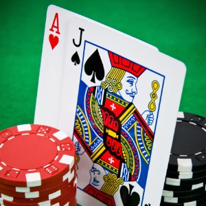 An image of two playing cards on agreen background with poker chips
