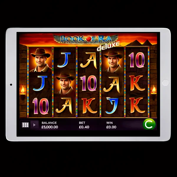 An image of a silver ipad on a black background with BOOK OF RA DELUXE online slot on the screen