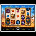 An image of a silver ipad on a black background, on the screen is an online slot game image of WHEEL OF WISHES
