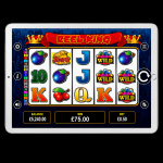 An image of a silver ipad on a black background, on the screen is an online slot game image of REEL KING