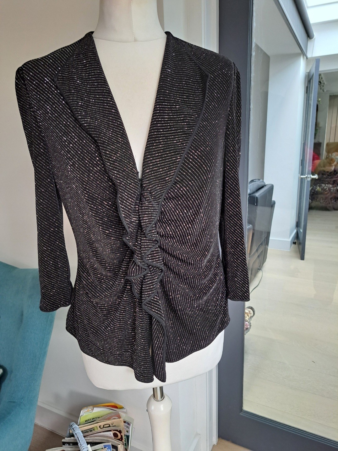 For A Sophisticated Evening Look,  A Black Lurex Stretch Ruffled Cardigan 14/16