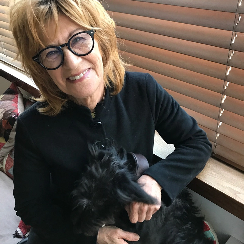 Marsha with a black dog named Eric