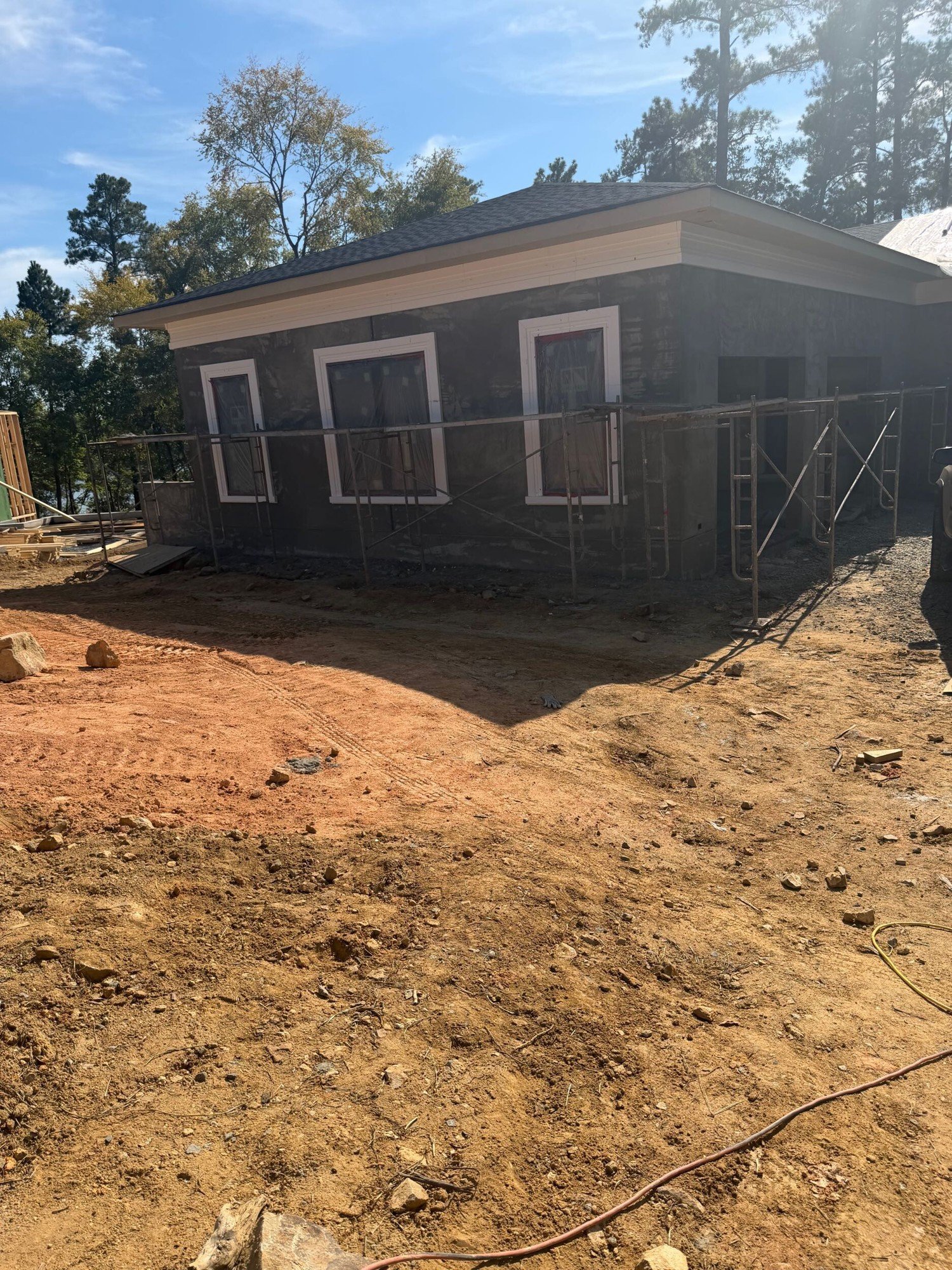 One wing of the McLean home with new stucco trim installed around its windows.