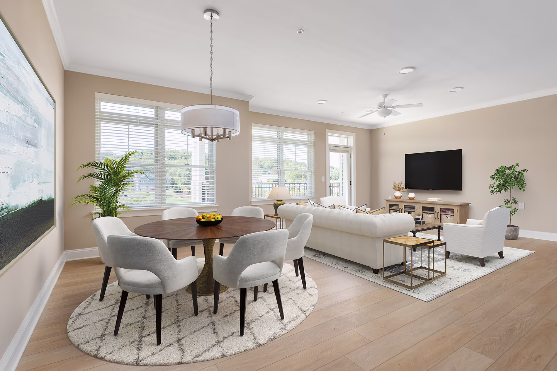 Spacious living room with a round dining table, chairs, large TV, and white sofa.