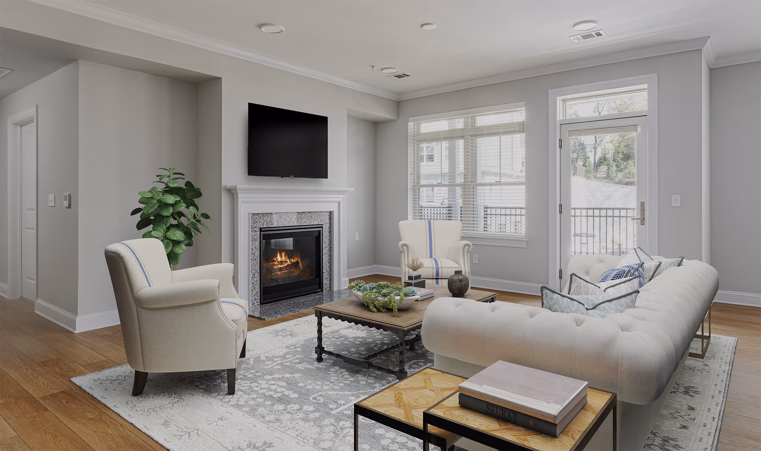 A living room with a fireplace, couch, and two chairs, centered around a coffee table.