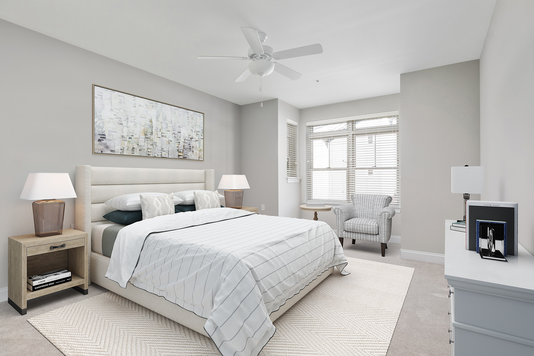 A tidy bedroom with a large bed, two bedside tables, and a striped armchair by the window.