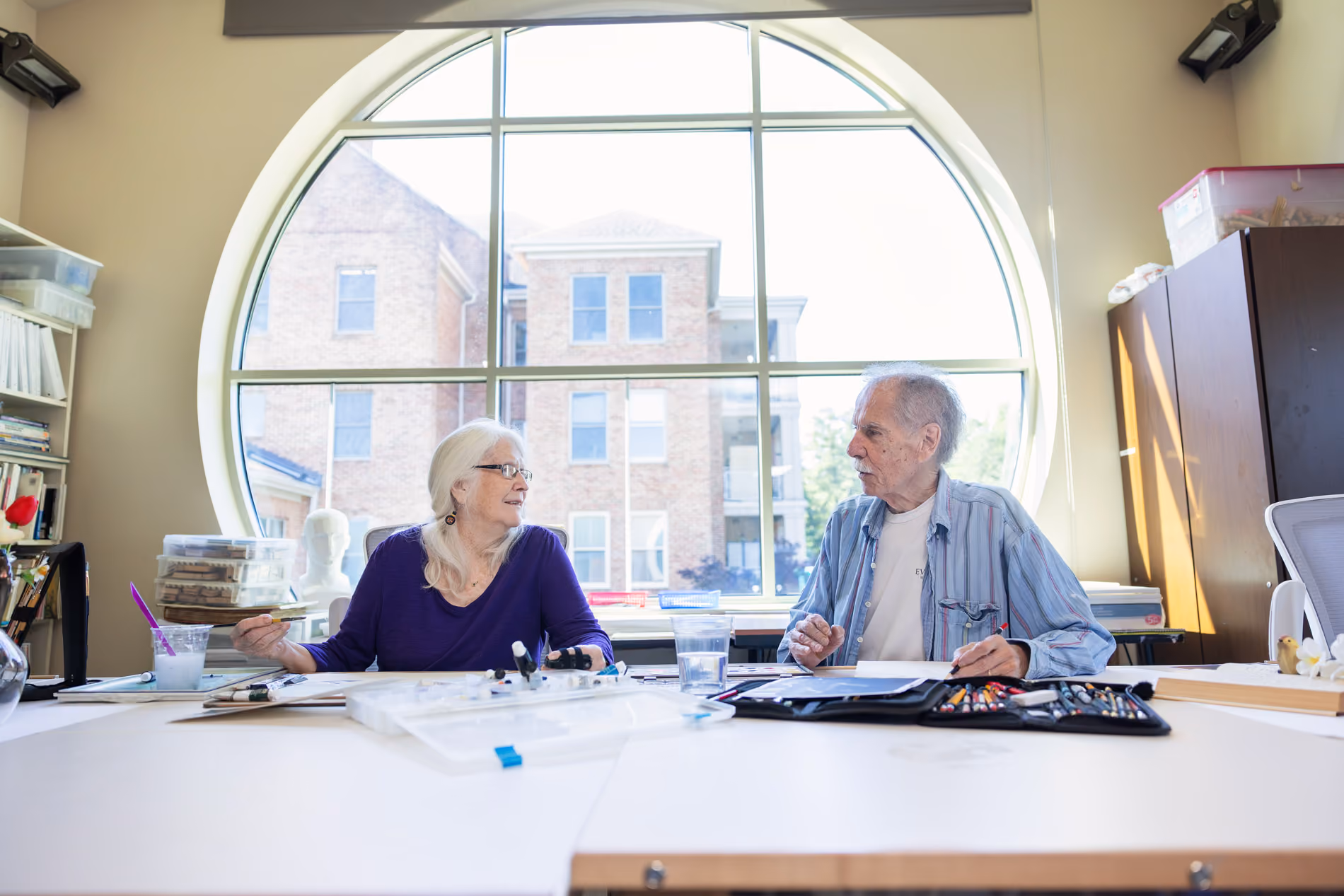 Senior living residents and staff interacting in a welcoming community setting indoors
