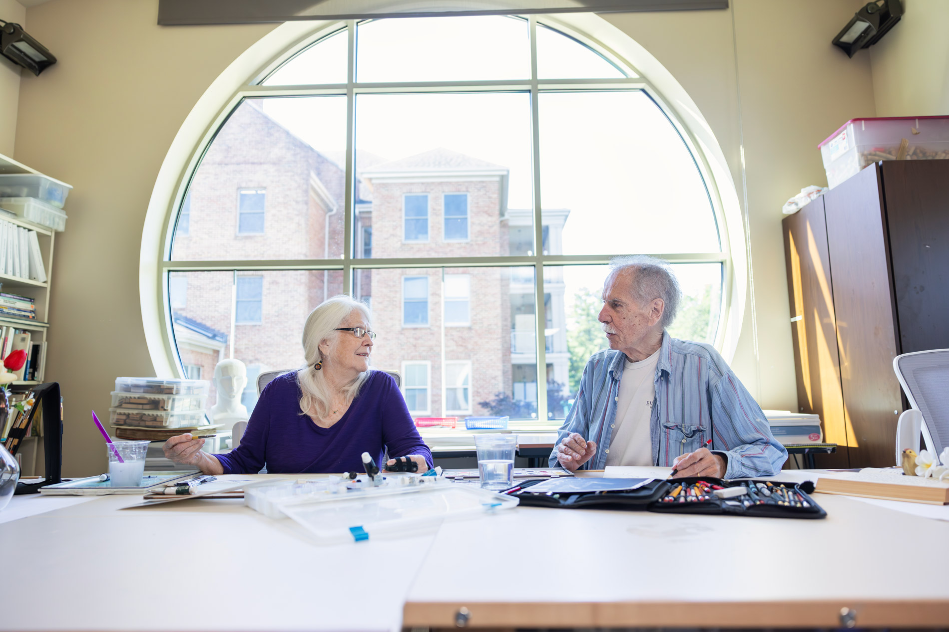 Senior living residents and staff interacting in a welcoming community setting indoors