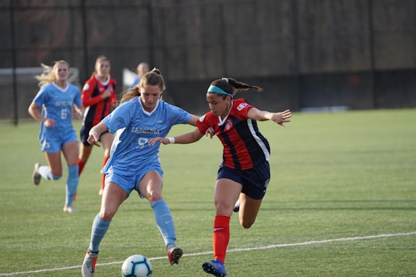 group of women playing on green field