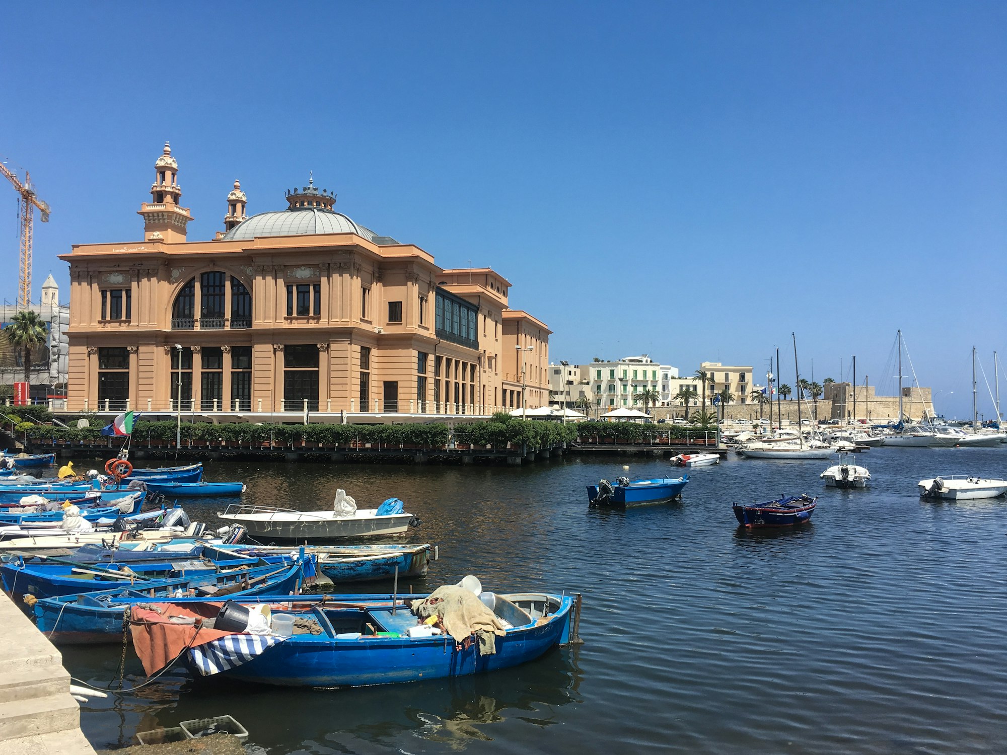 Blue and white fishing boats in front of Bari's waterfront